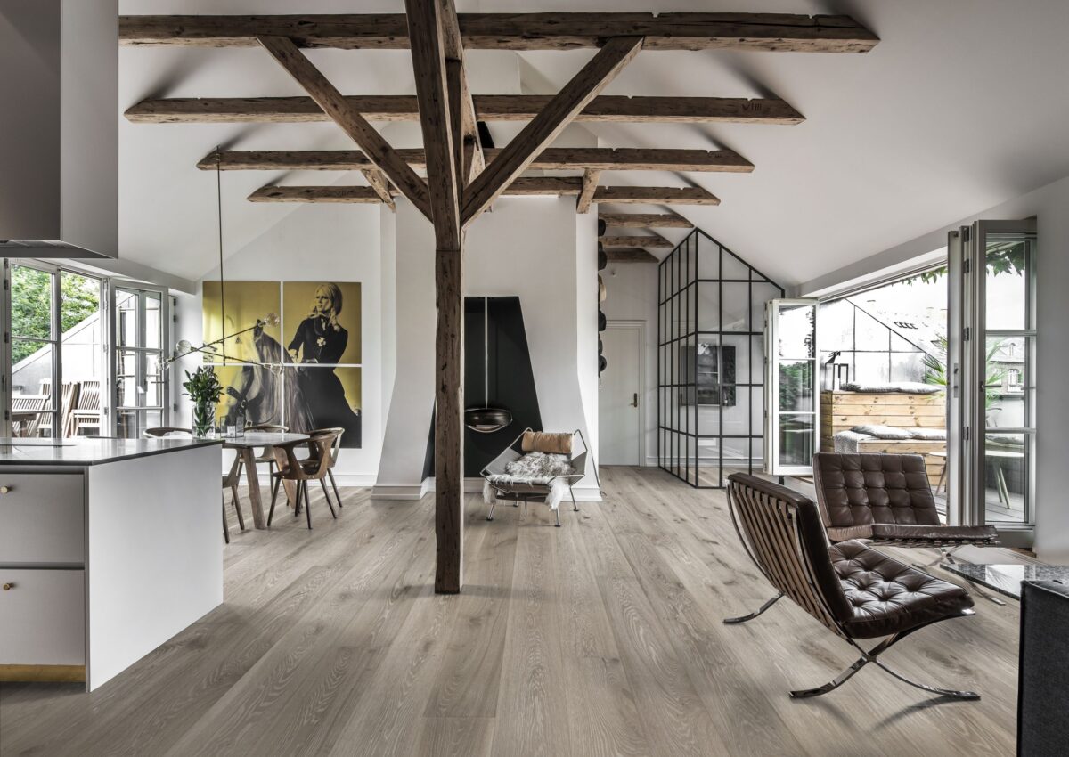 Decorated indoor room with natural lighting and Kahrs Oak Nouveau Gray Prefinished Hardwood.