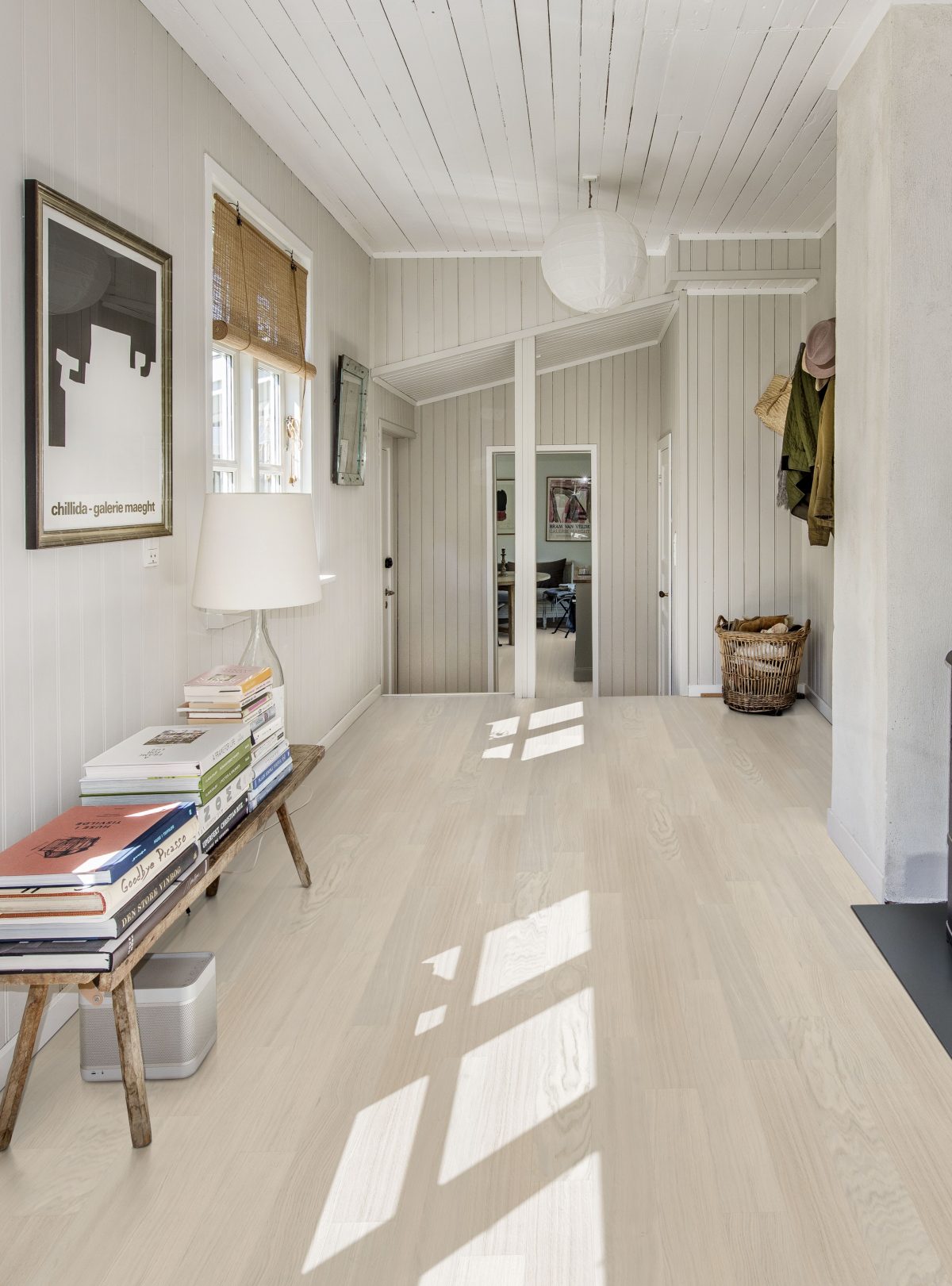 Decorated indoor room with natural lighting and Kahrs Coconut Cream Narrow Prefinished Hardwood.