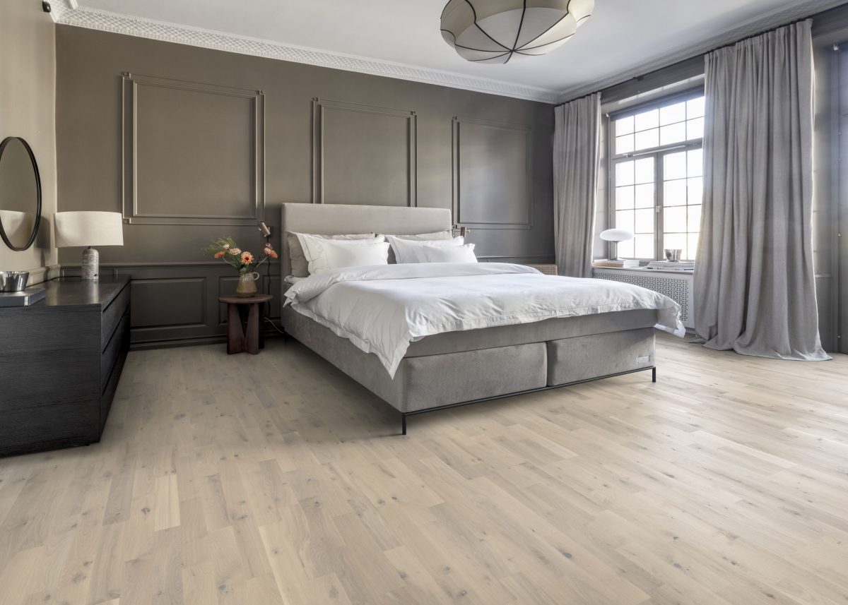 Decorated bedroom space with Kahrs Loft White Strip Prefinished Hardwood.