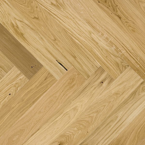 Close up of Barlinek Oak Caramel Herringbone Prefinished Hardwood.